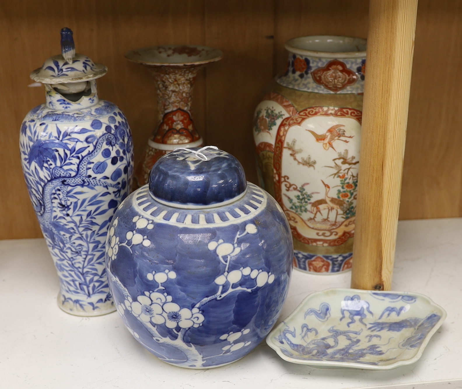 A Chinese blue and white lidded baluster vase, with damage, together with a lidded prunus ginger jar, a Japanese Kutani Export vase, a small blue and white dish (5), baluster vase and cover 27.5 cm high